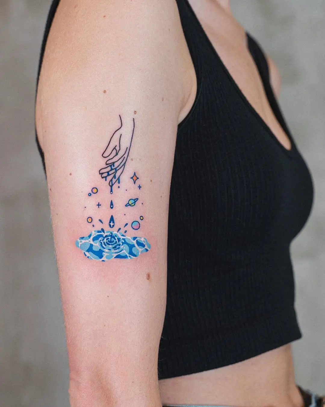 Elegant hand reaching towards a blue rose