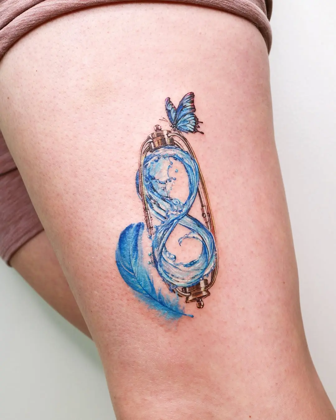 Fluid art meets infinity design in tattoos