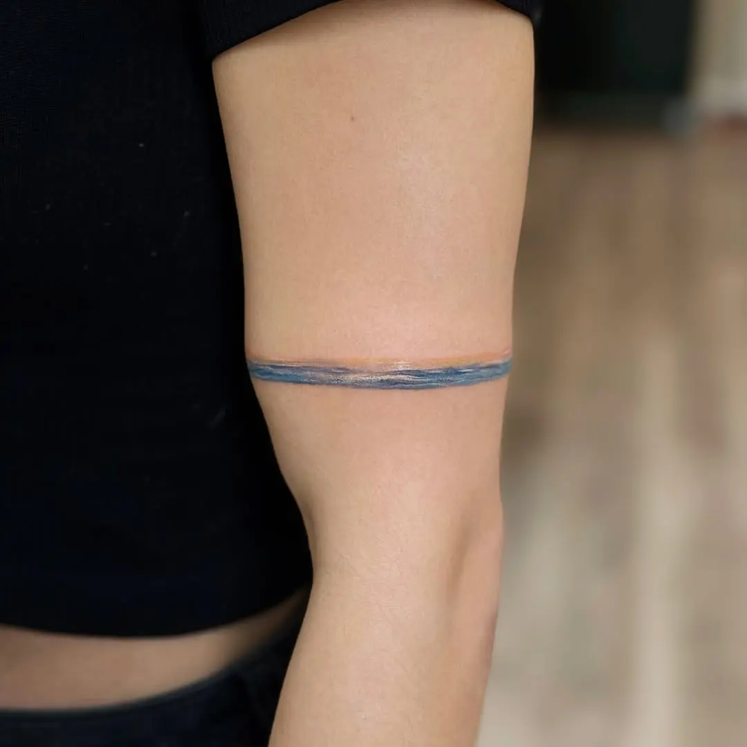 Elegant minimalism in water-themed tattoo art