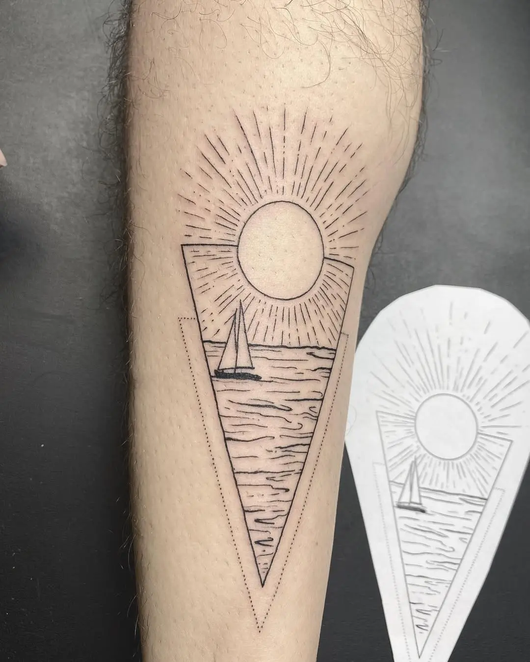 Charming water-themed tattoo with sun and sailboat