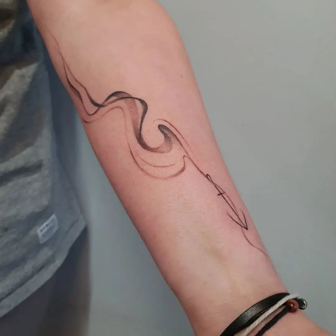 Elegant water wave tattoo on forearm