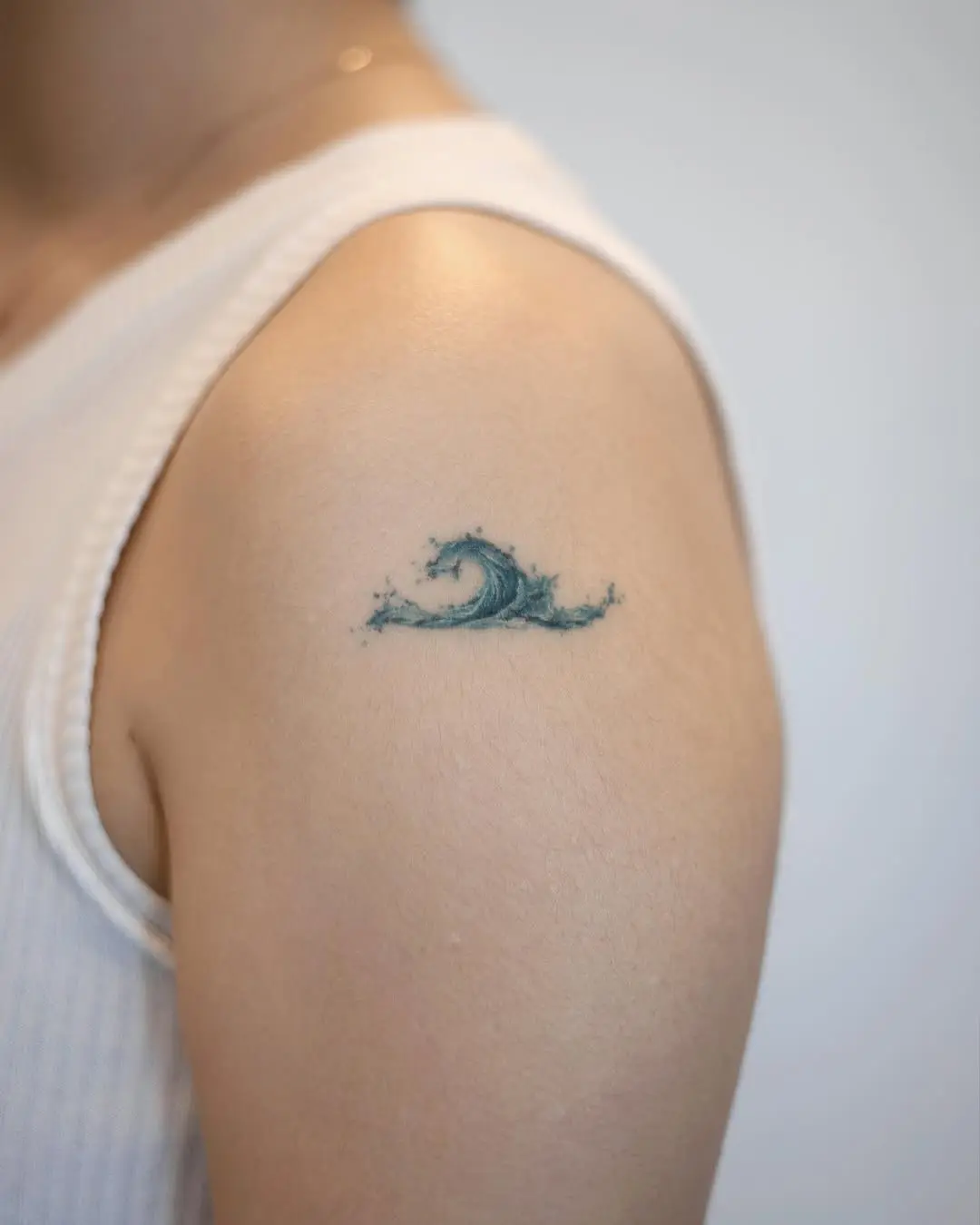 Elegant wave tattoo on the shoulder