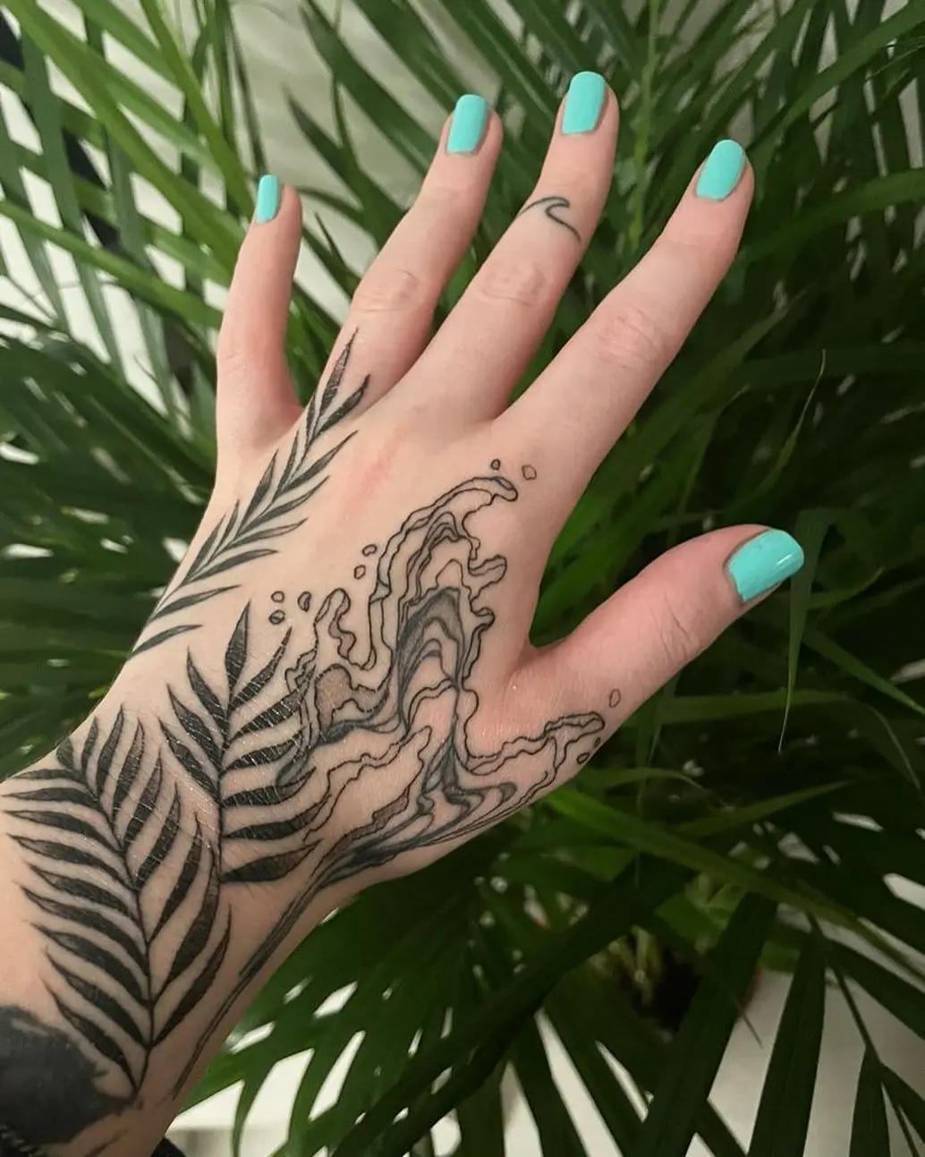 Flowing water tattoo meets elegant foliage design