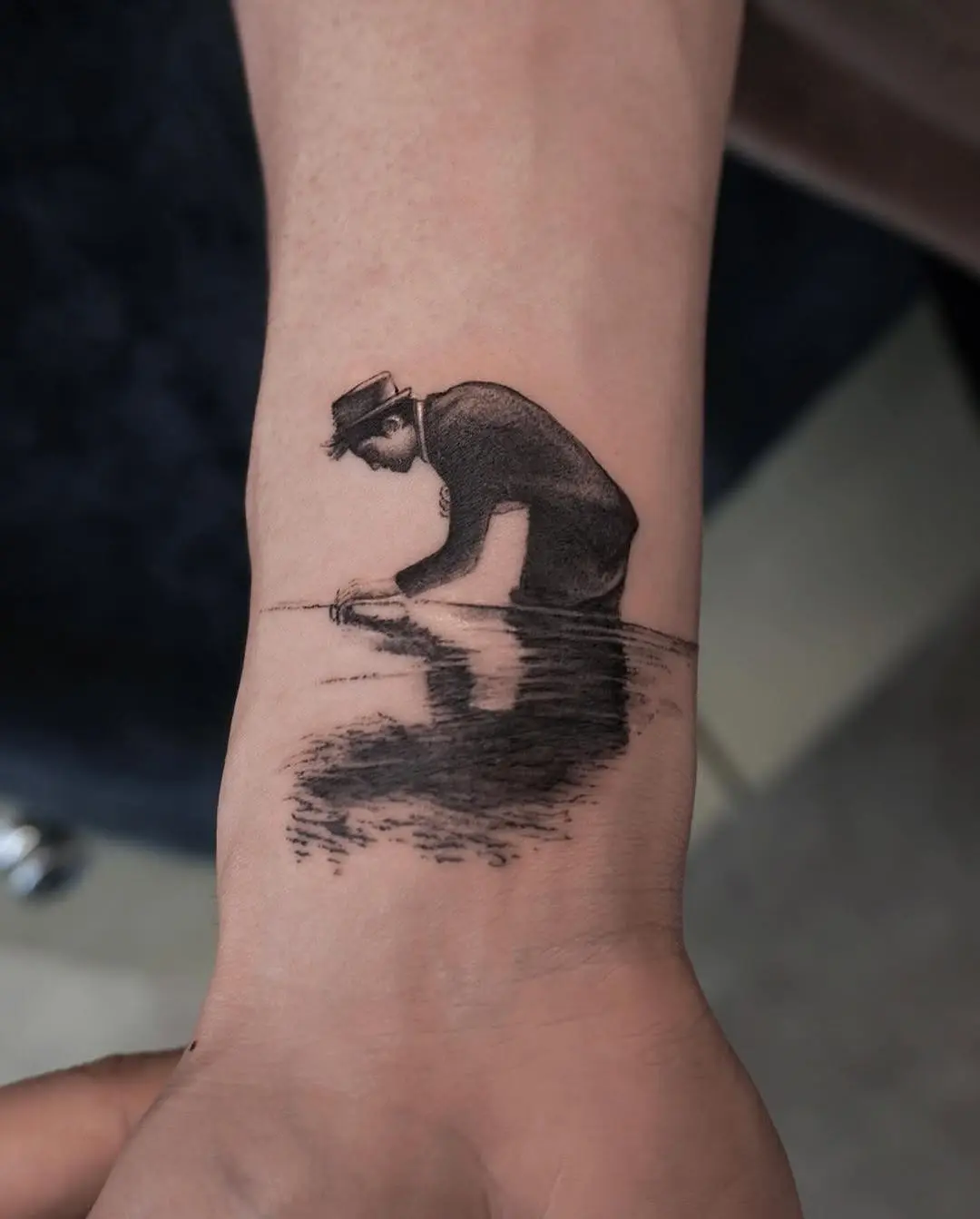 Artistic tattoo of man interacting with water