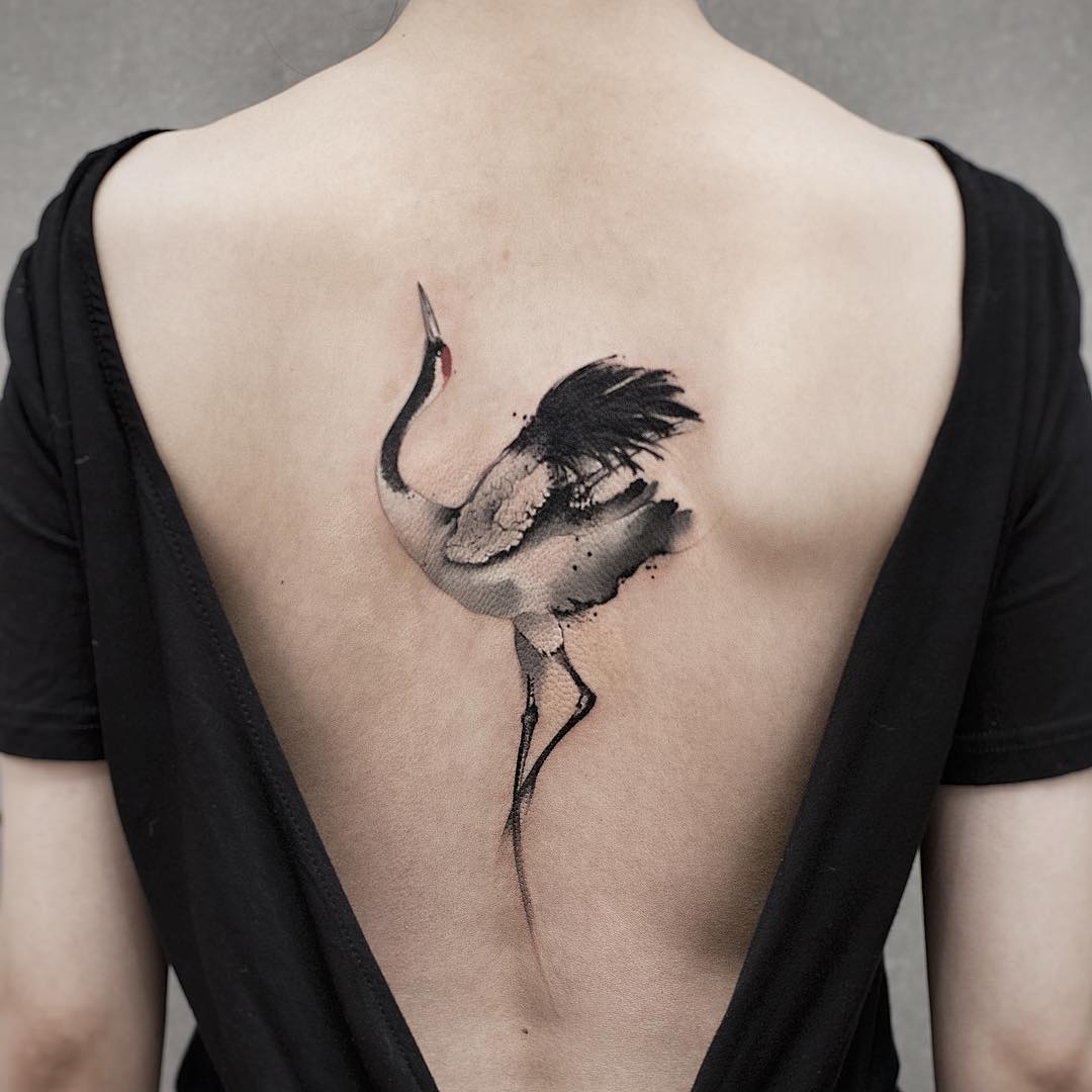 Elegant crane watercolor tattoo on the back