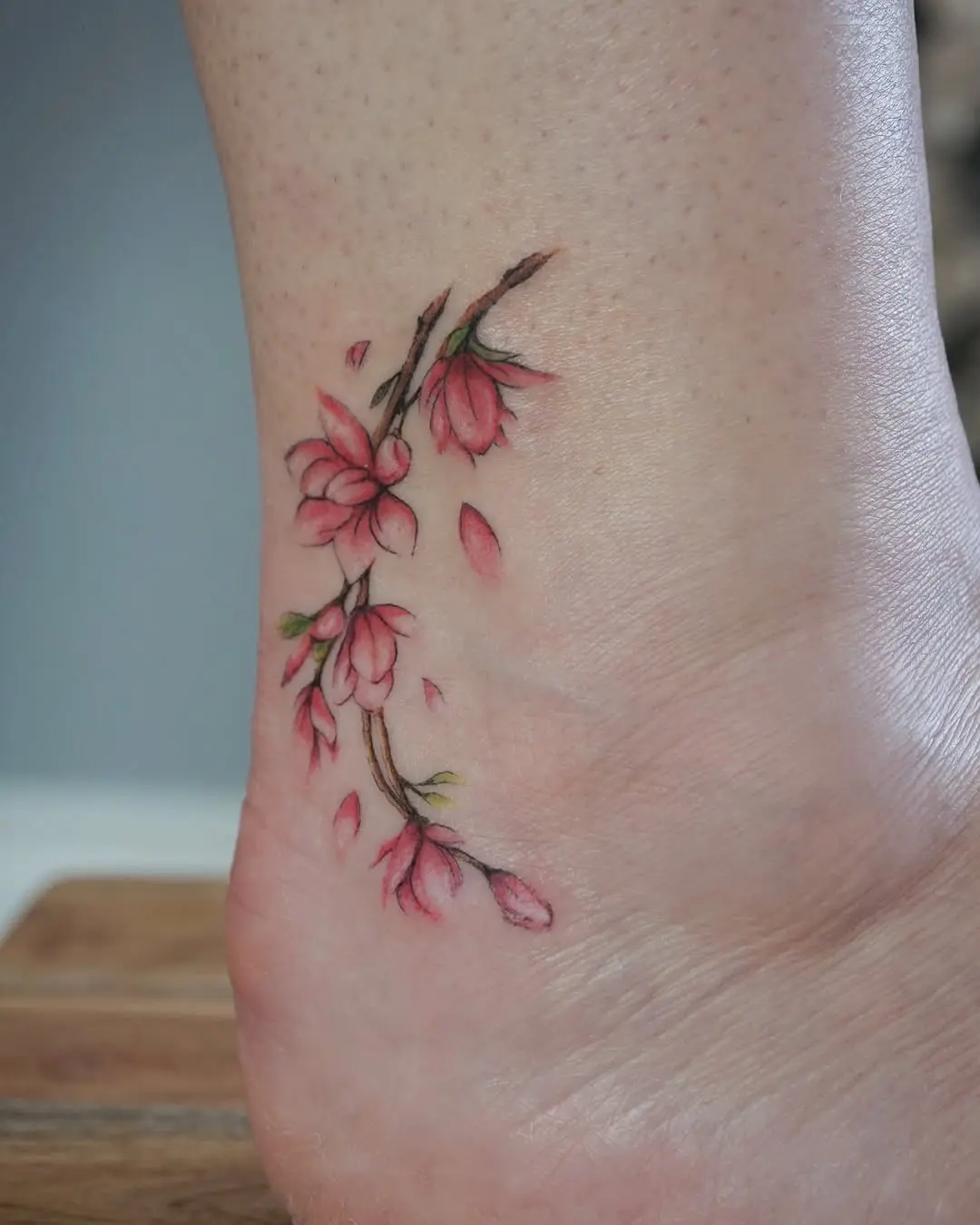 Elegant watercolor floral ankle tattoo design