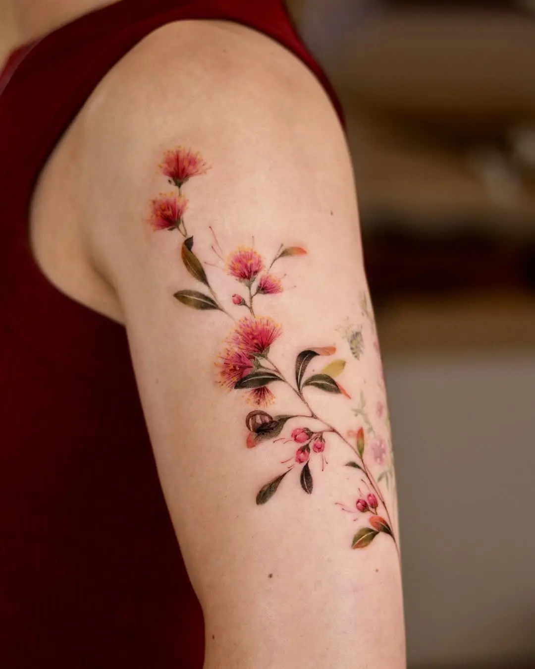 Delicate floral watercolor arm tattoo design