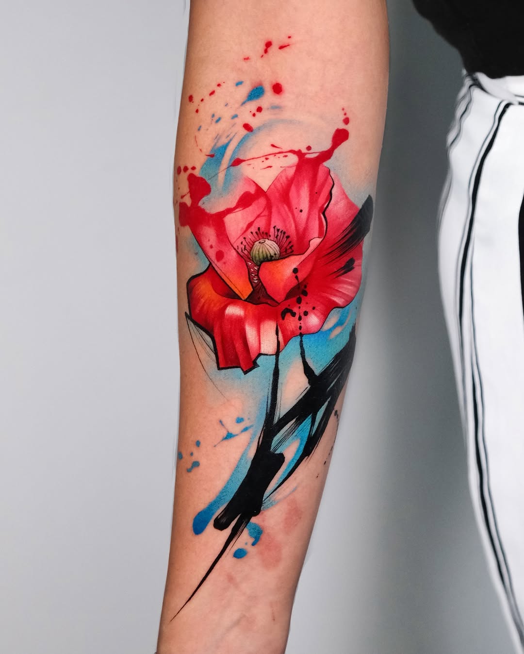 Bold red floral watercolor tattoo design