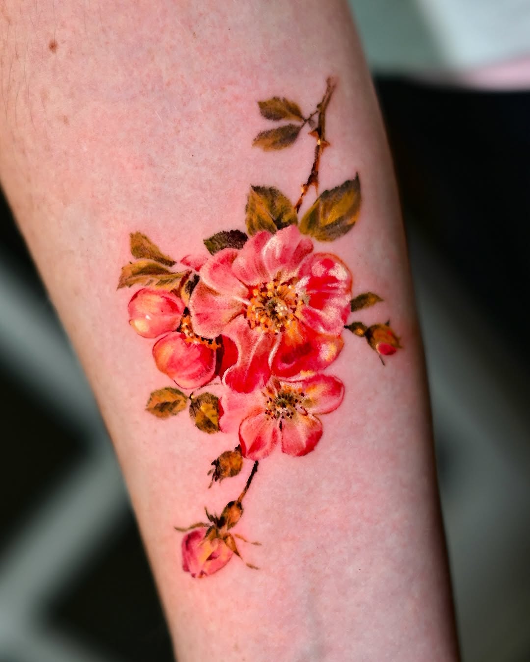 Elegant watercolor rose tattoo showcasing vibrant colors