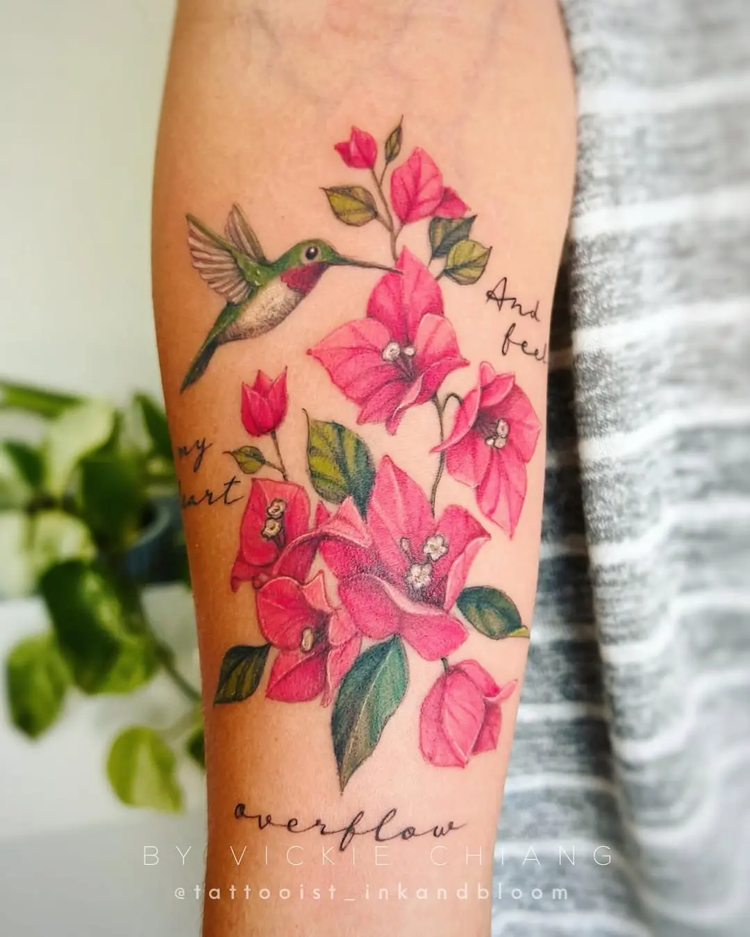 Vivid floral watercolor tattoo with hummingbird