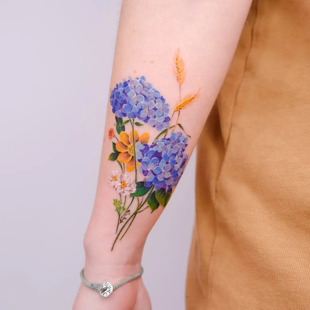Stunning watercolor floral tattoo on the arm