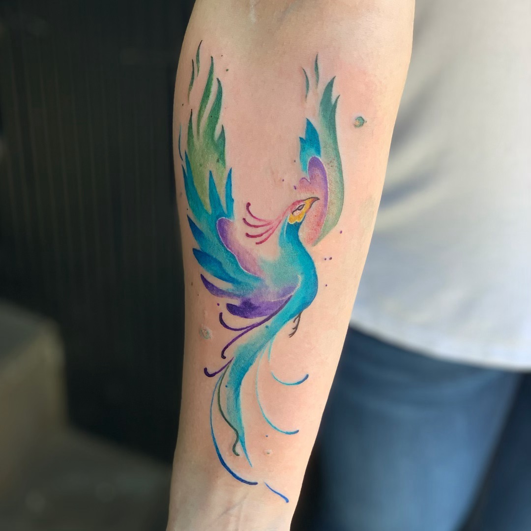 Vibrant watercolor phoenix tattoo in motion