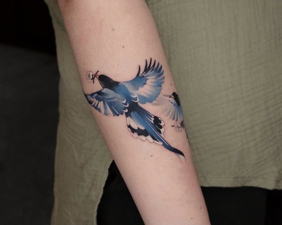 Vivid watercolor bird tattoo in motion