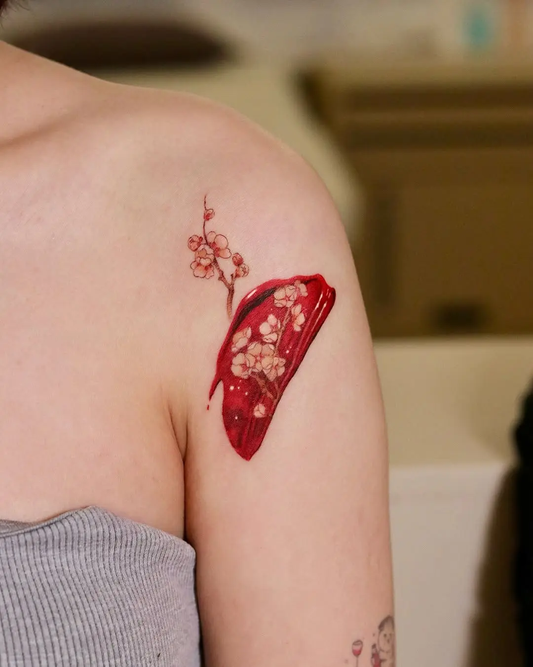 Elegant red floral watercolor tattoo design