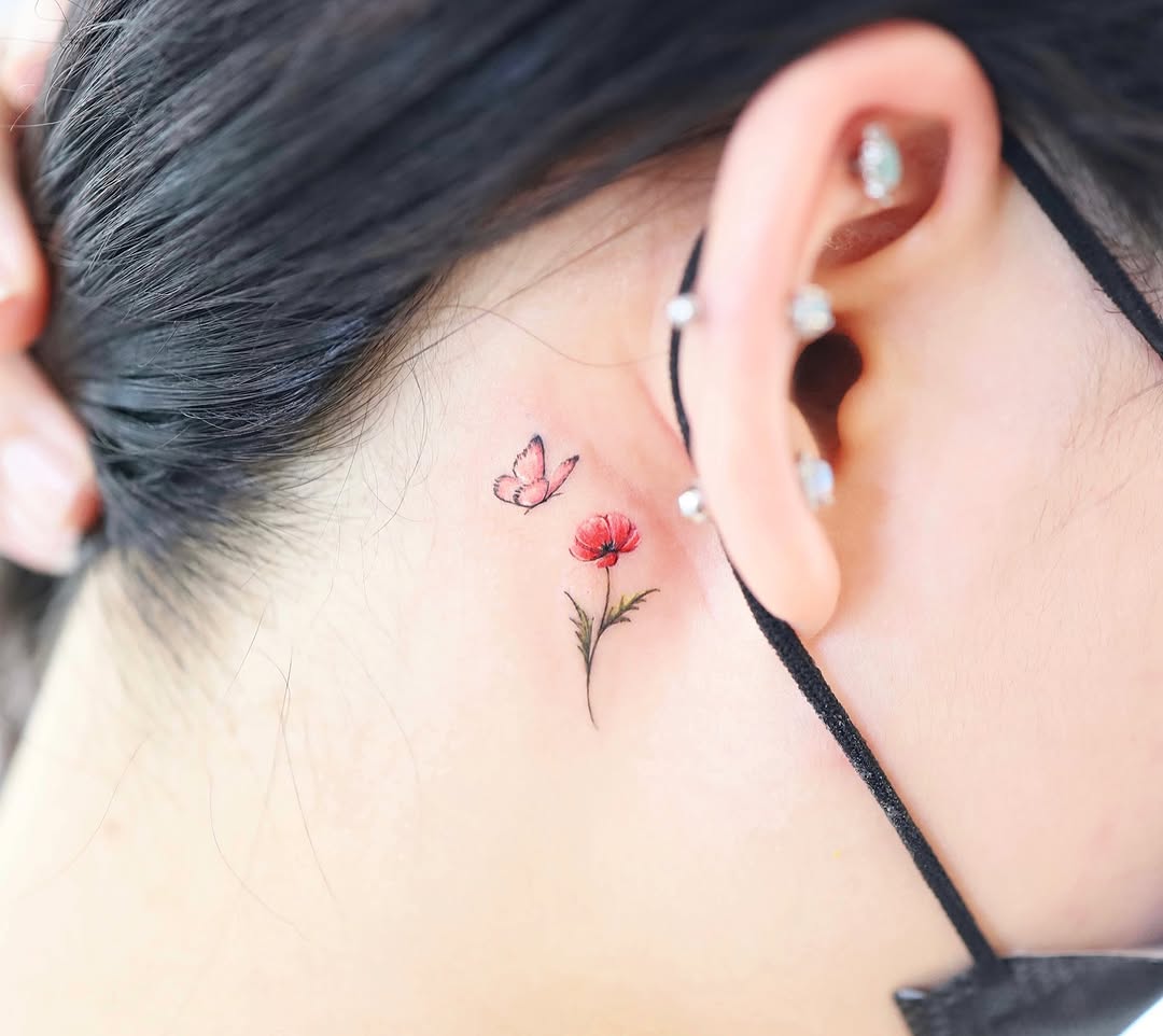 Delicate watercolor butterfly and flower tattoo