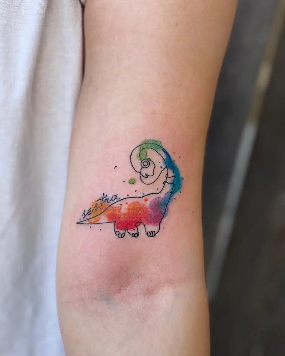 Vibrant watercolor dinosaur tattoo with flowing colors