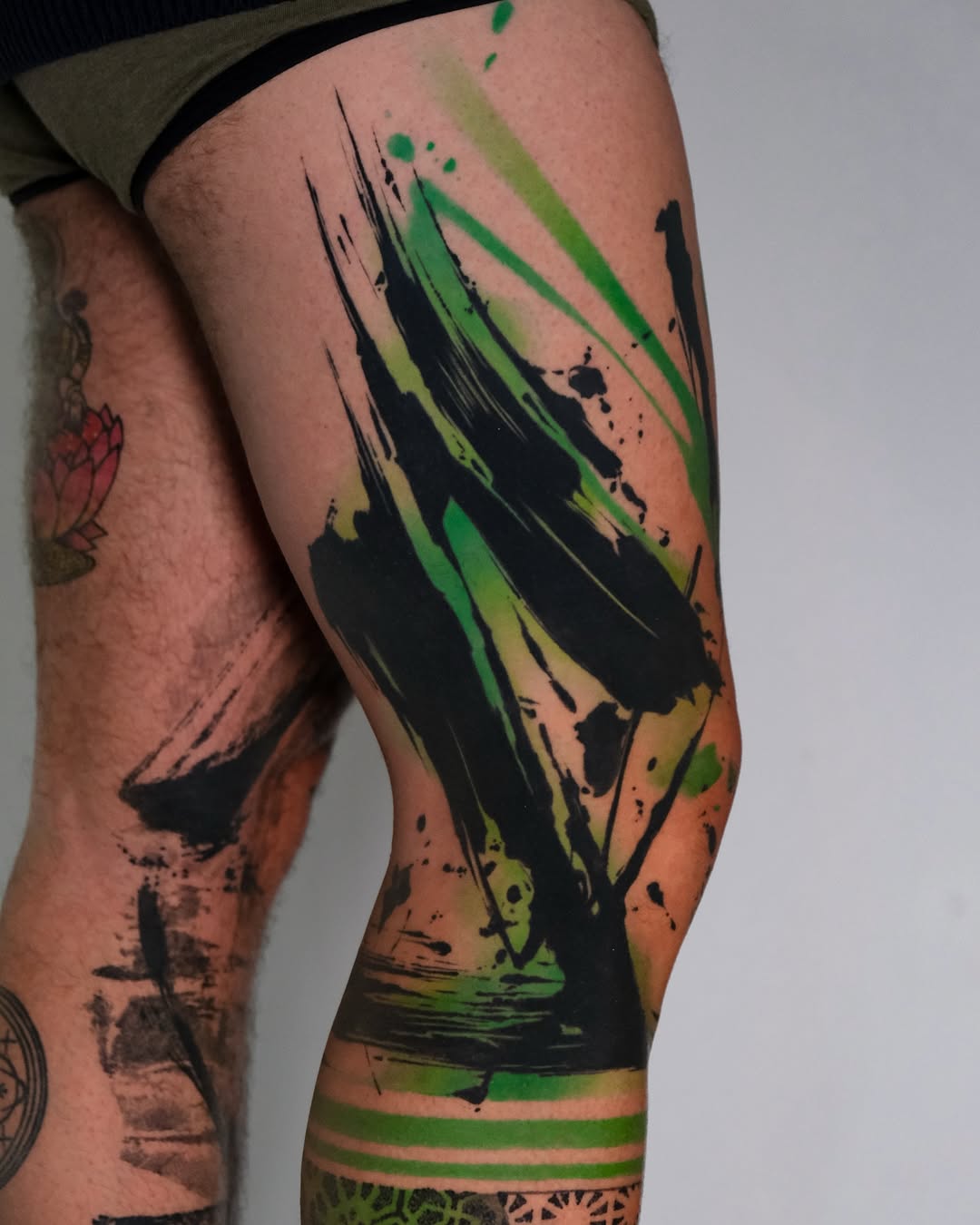 Dynamic splash of green and black ink