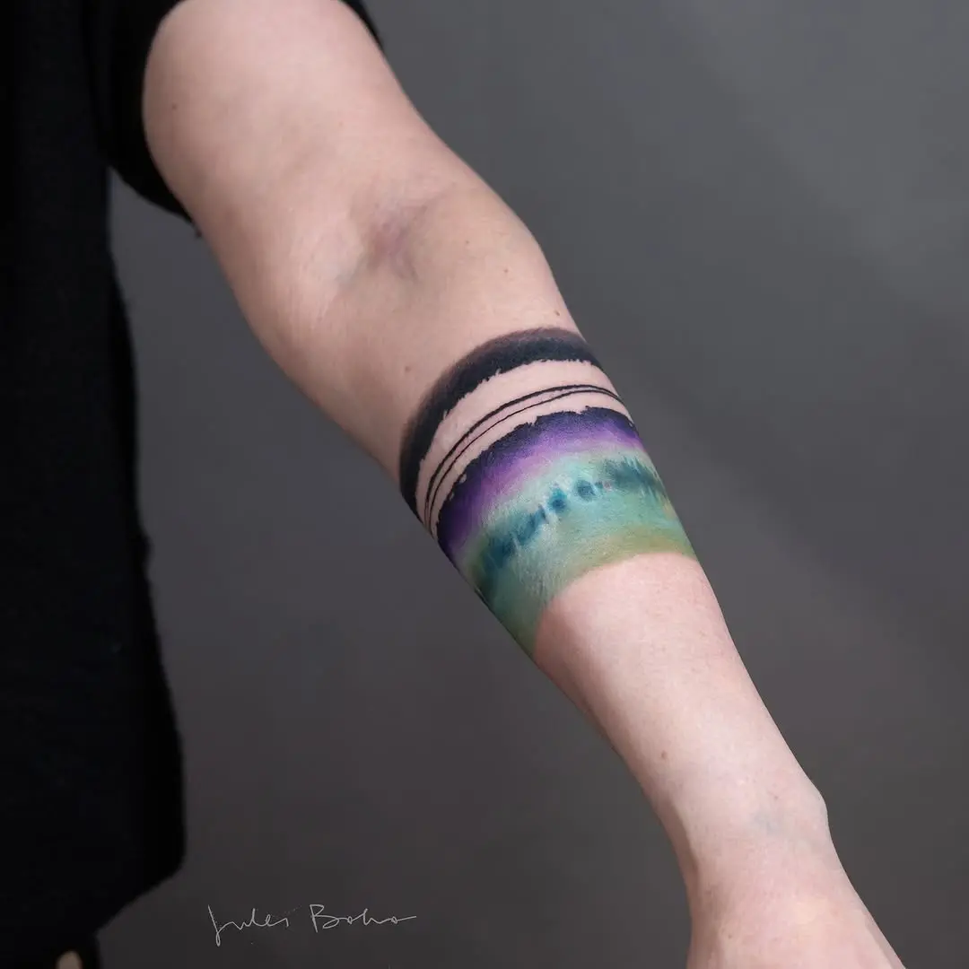 Vibrant hues of nature-inspired watercolor tattoo
