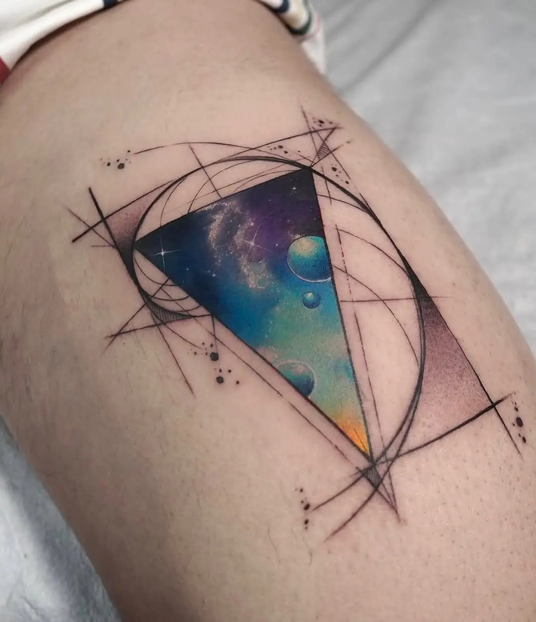 Stunning geometric watercolor tattoo with cosmic elements