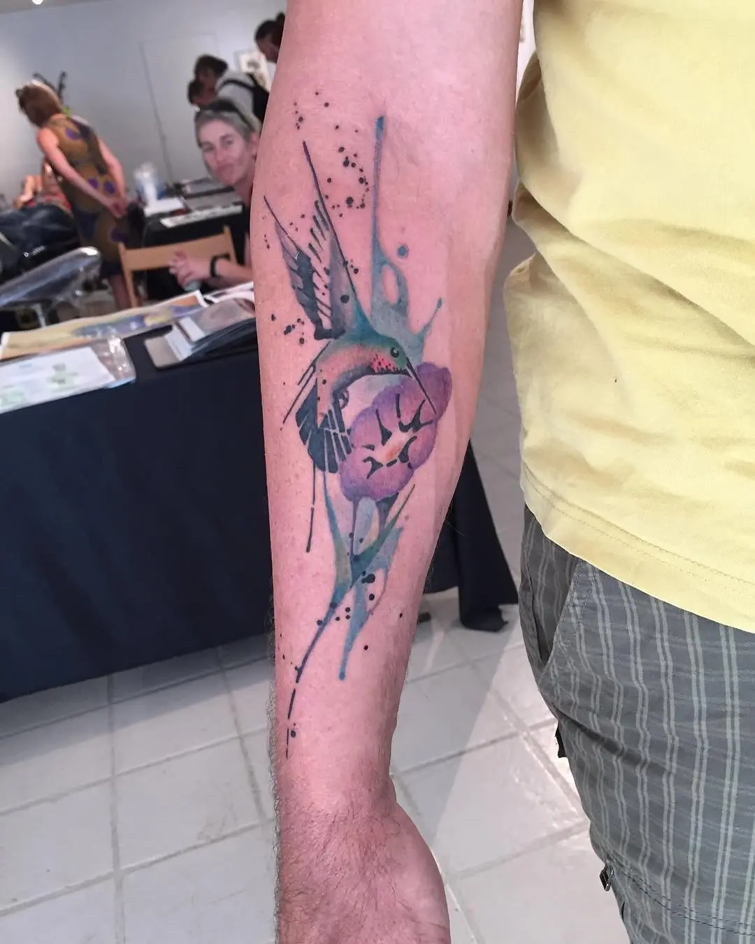 Vibrant hummingbird amidst floral watercolor hues