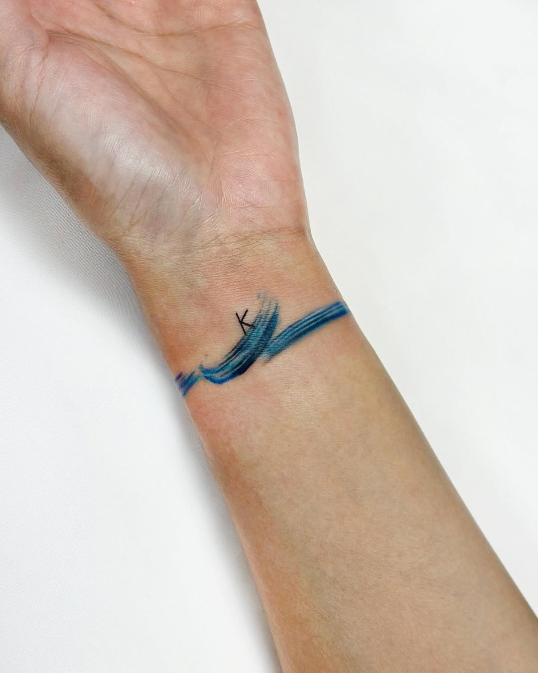 Minimalist watercolor tattoo on the wrist