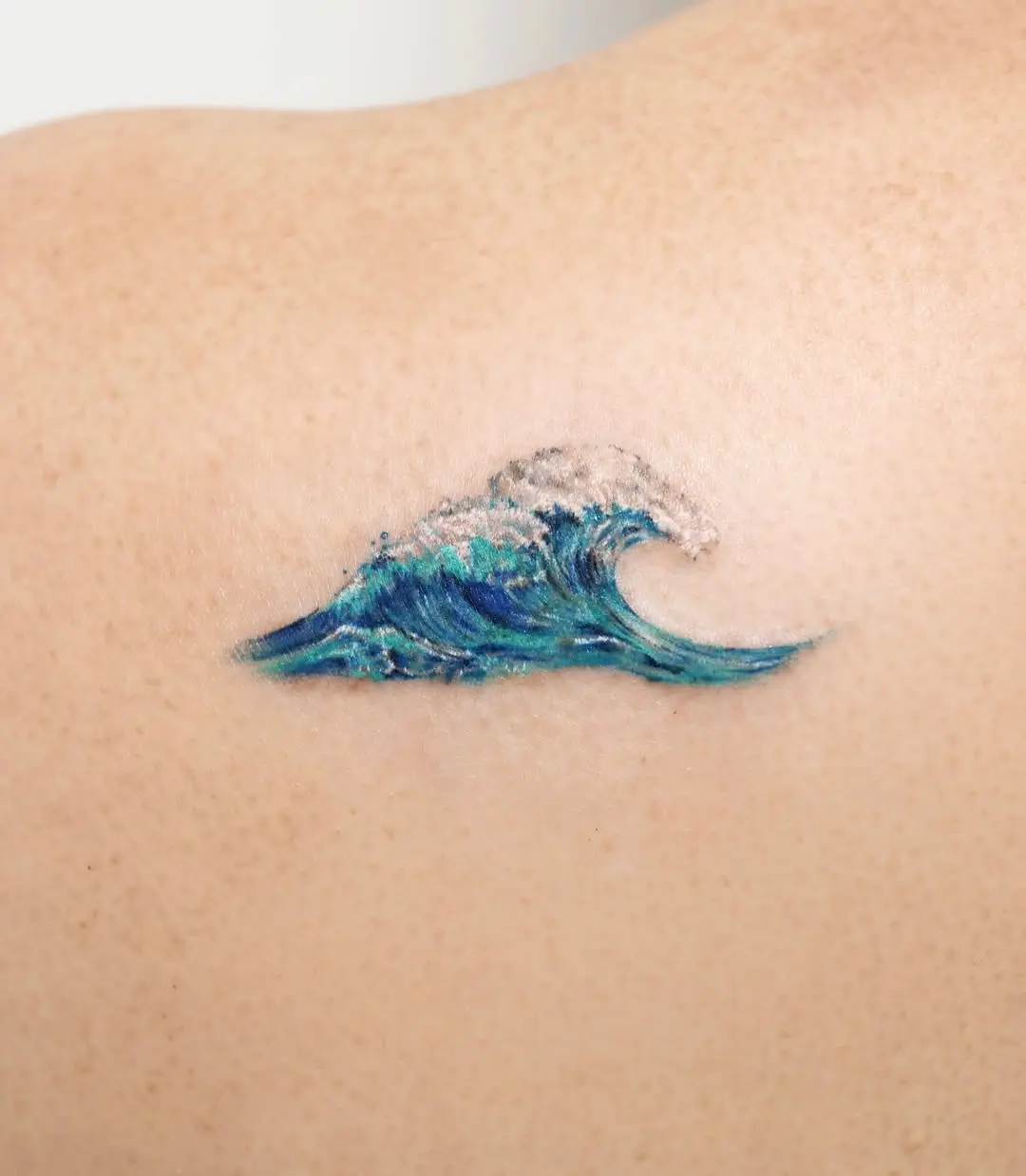 Vibrant wave tattoo with rich colors