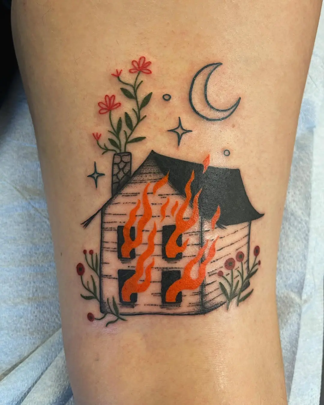 Charming house tattoo engulfed in flames