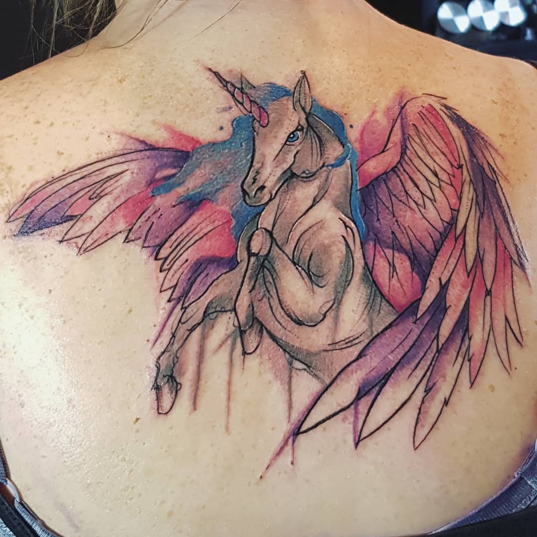 Majestic unicorn tattoo with whimsical elements