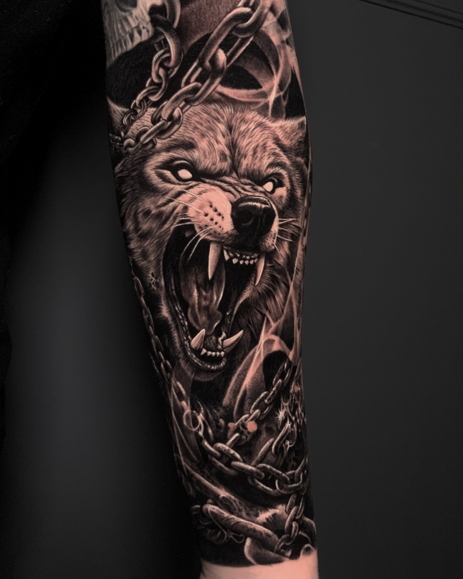 Intense wolf tattoo showcasing fierce energy.