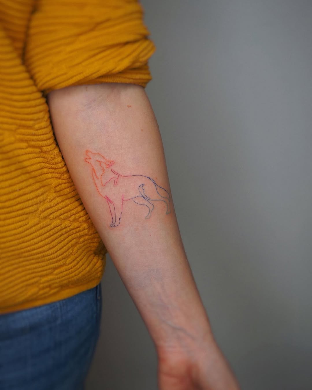 Stylish and minimalistic wolf outline tattoo