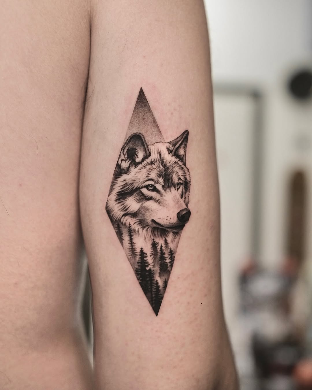 Stunning wolf tattoo with forest backdrop detail