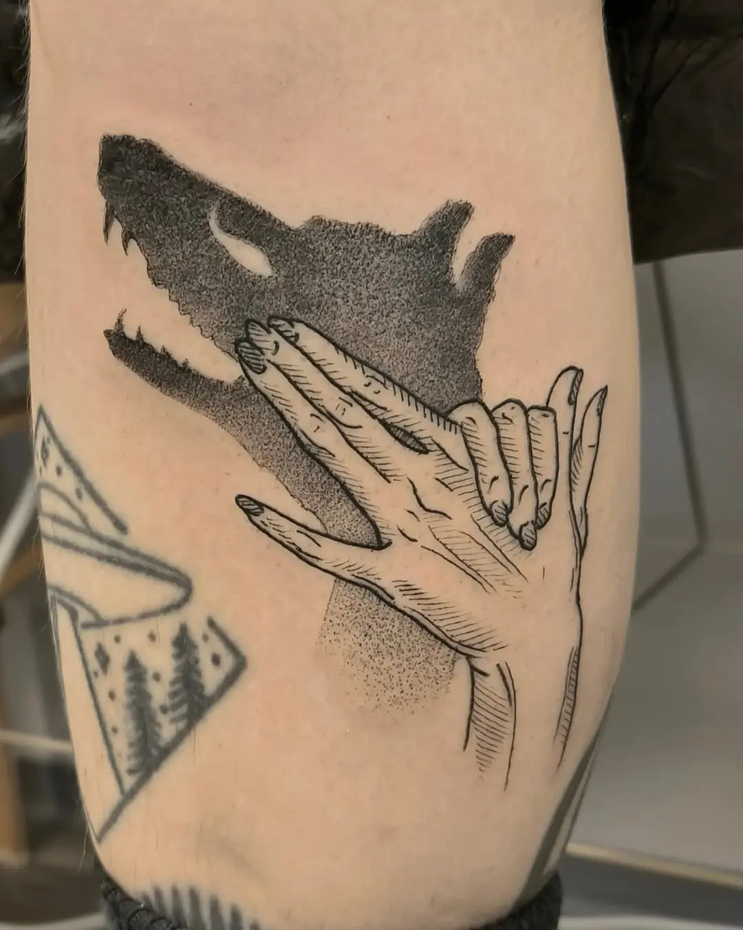 Intricate design blending hands and wolf silhouette