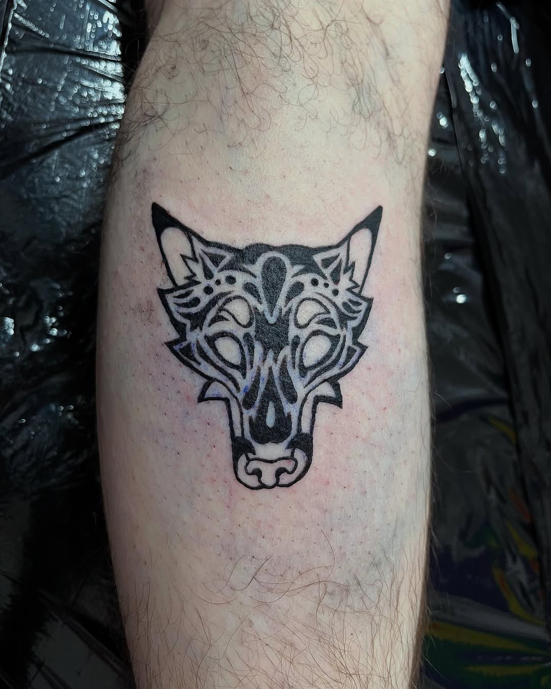 Intricate Black Ink Wolf Head Tattoo Design