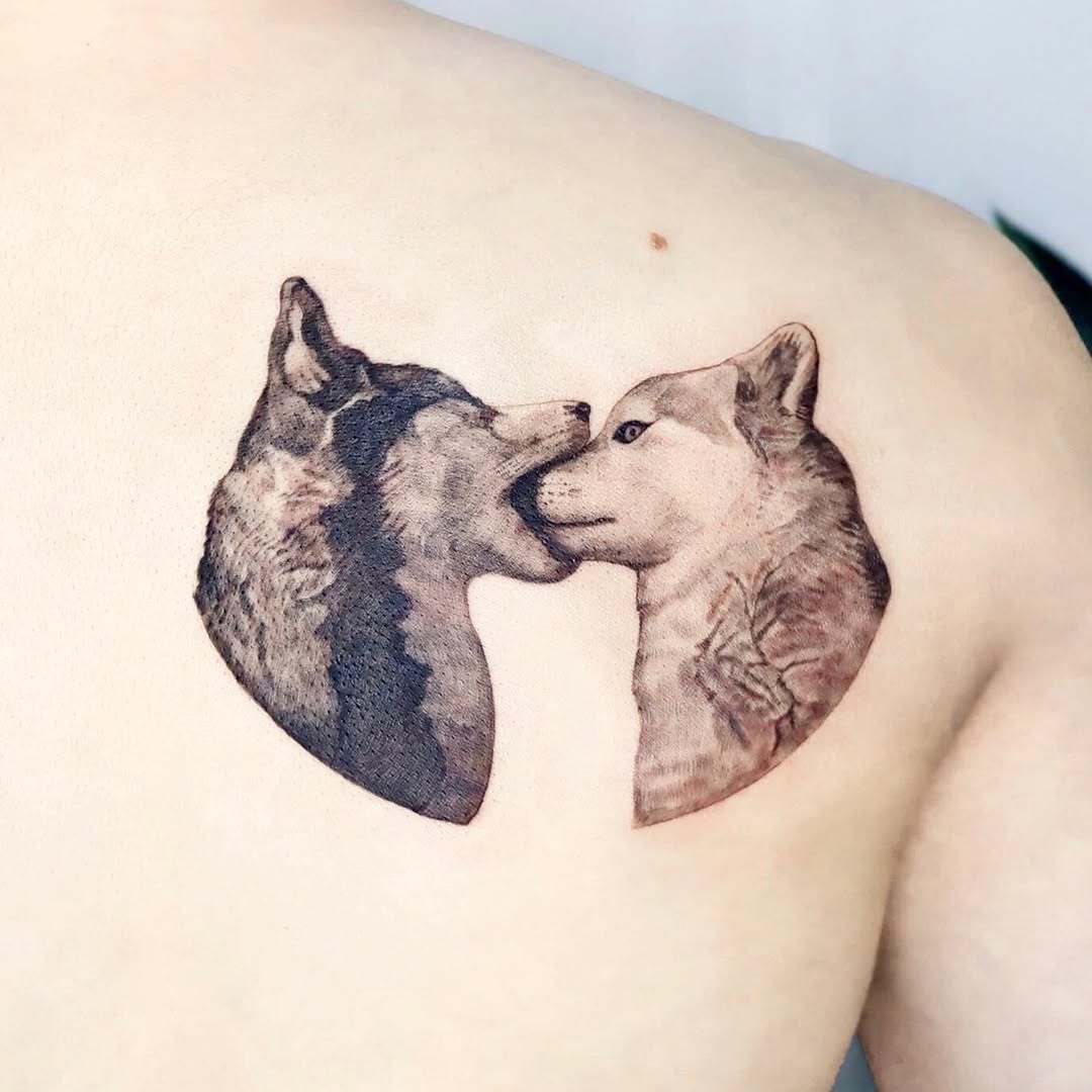 Intricate wolves embracing in stunning tattoo art