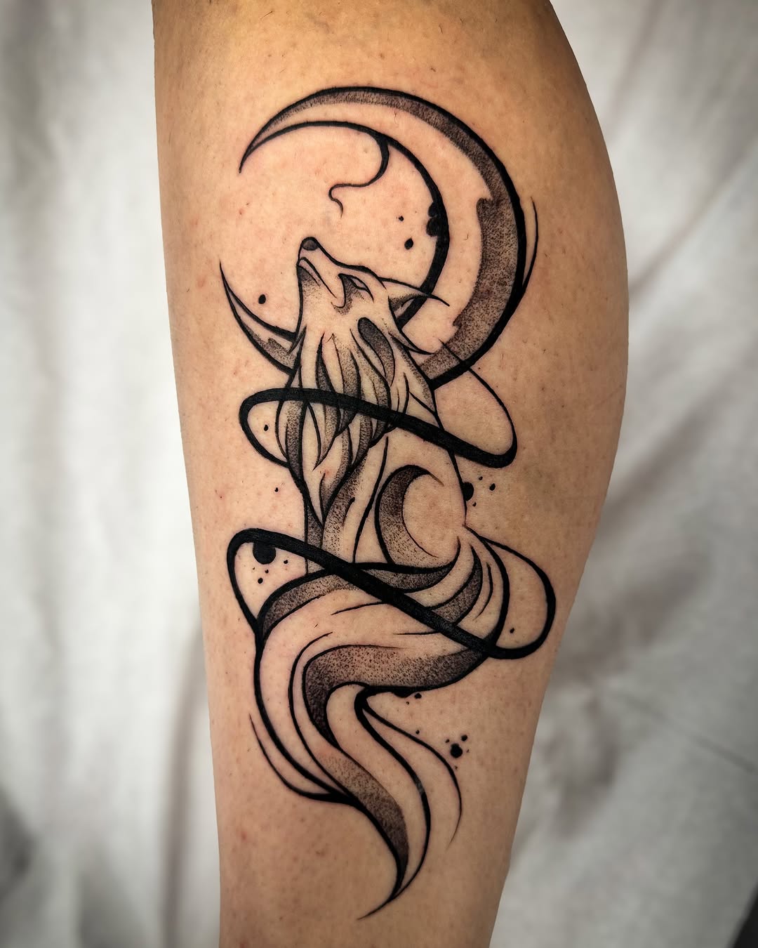 Elegant wolf tattoo with crescent moon design