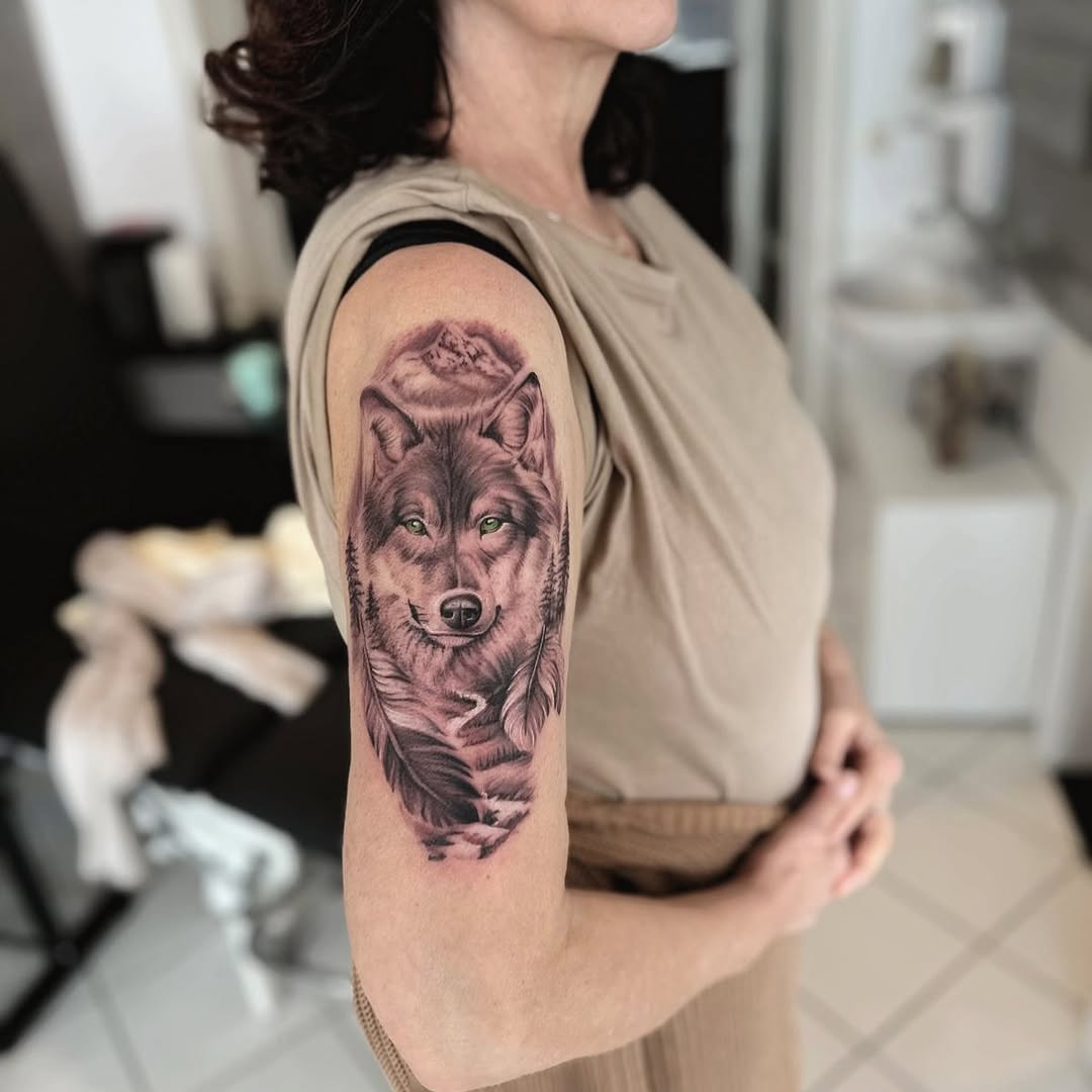 Realistic wolf tattoo on feminine arm