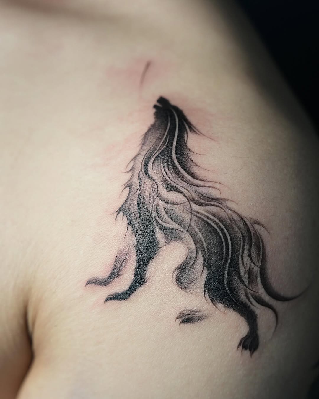 A howling wolf silhouette with flowing lines