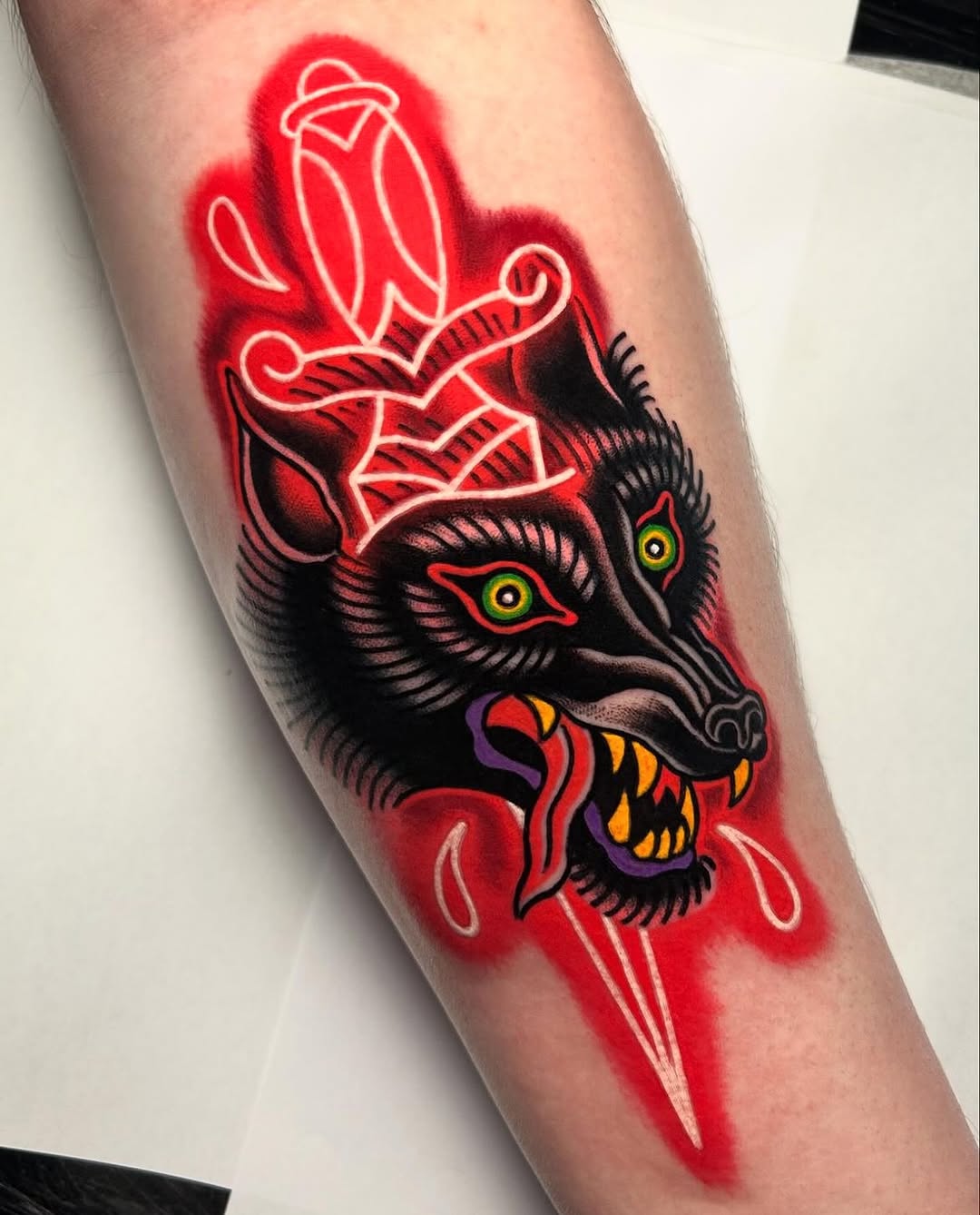 Striking wolf tattoo with bold, vibrant colors