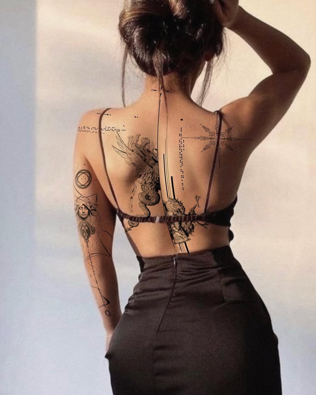 Artistic floral and geometric back tattoos