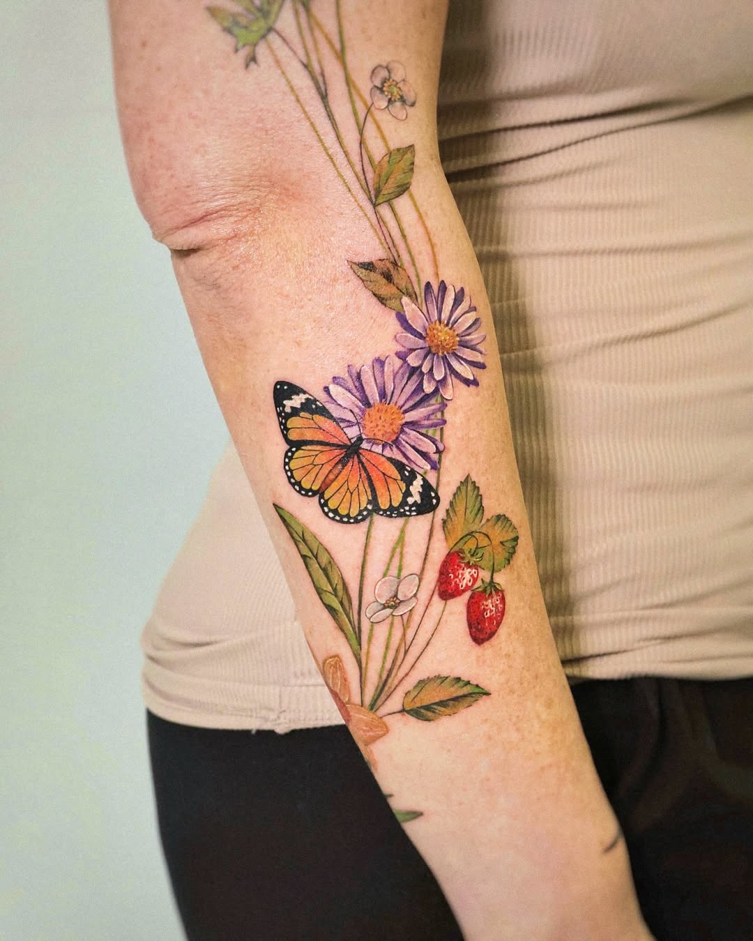 Vibrant Floral Sleeve Tattoo with Butterfly Accent