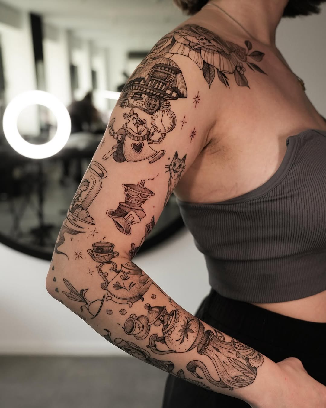 Whimsical sleeve tattoo featuring playful tea motifs