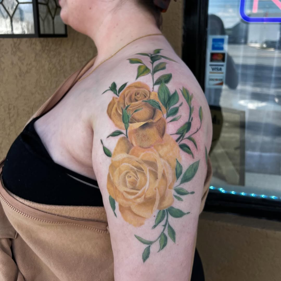 Elegant yellow rose tattoos on graceful shoulder