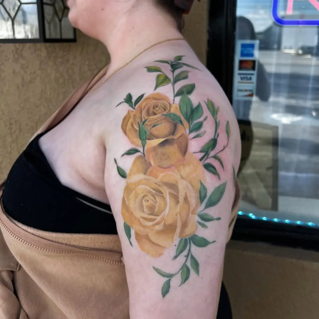 Elegant yellow rose tattoos on graceful shoulder