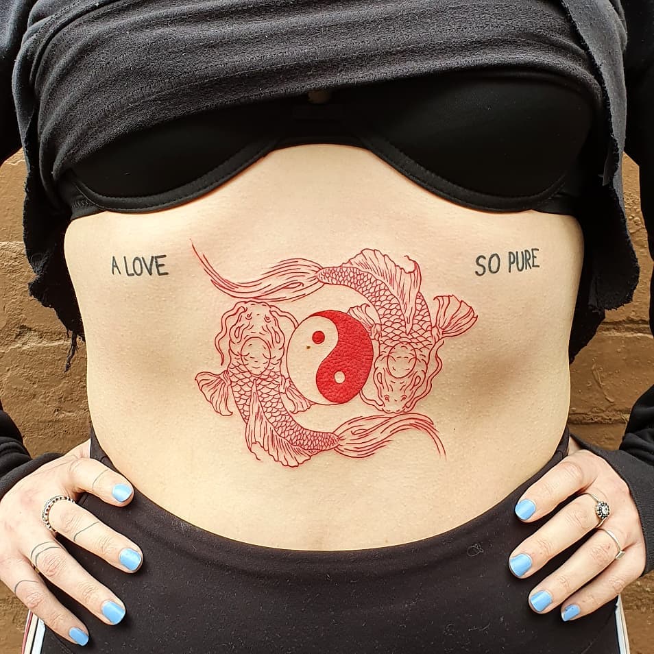 Intricate yin yang tattoo with koi fish design