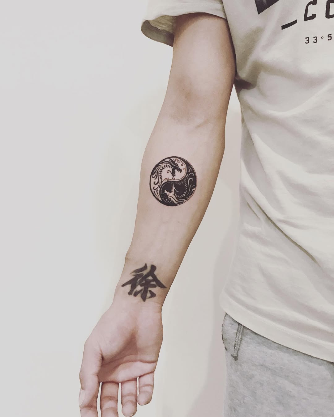 Elegant yin yang tattoo on forearm