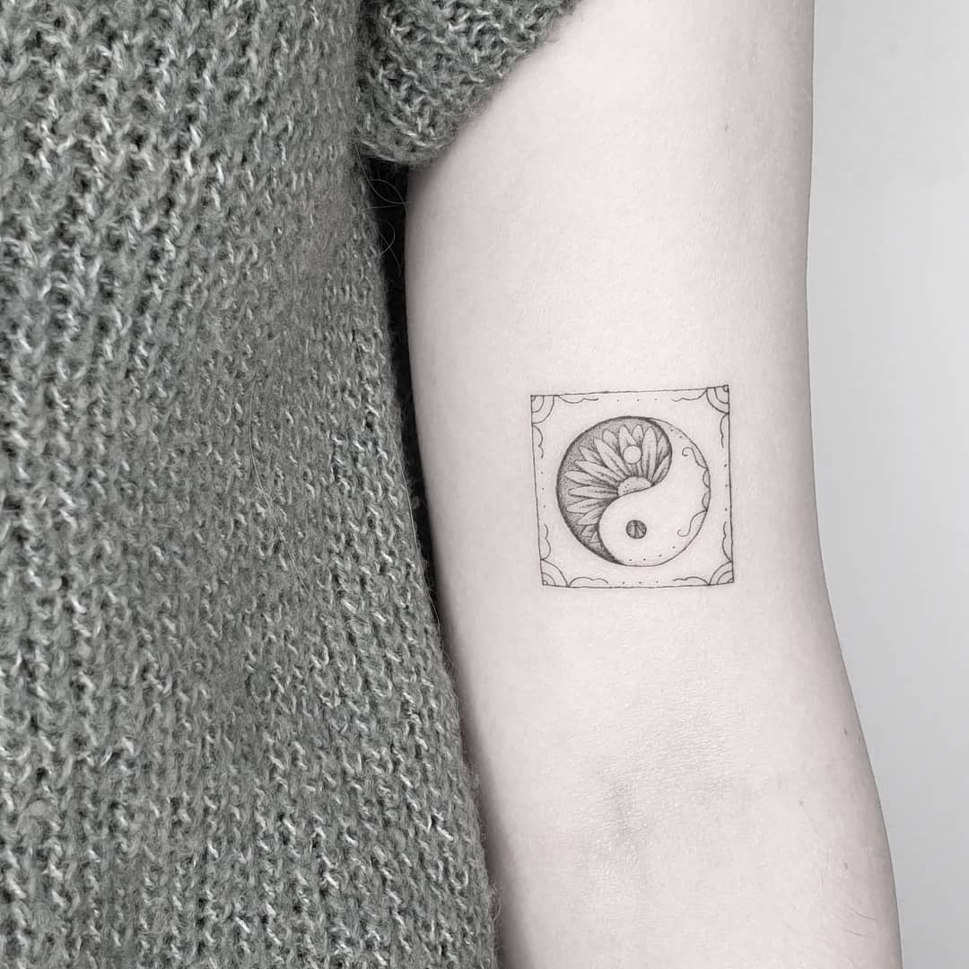 Elegant yin yang tattoo with floral elements