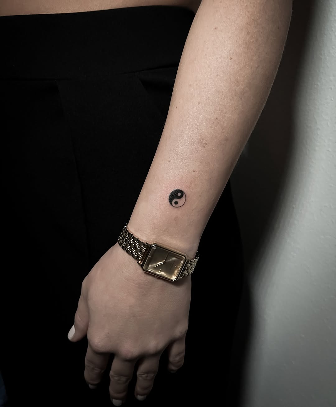 Minimalist yin yang tattoo on the wrist