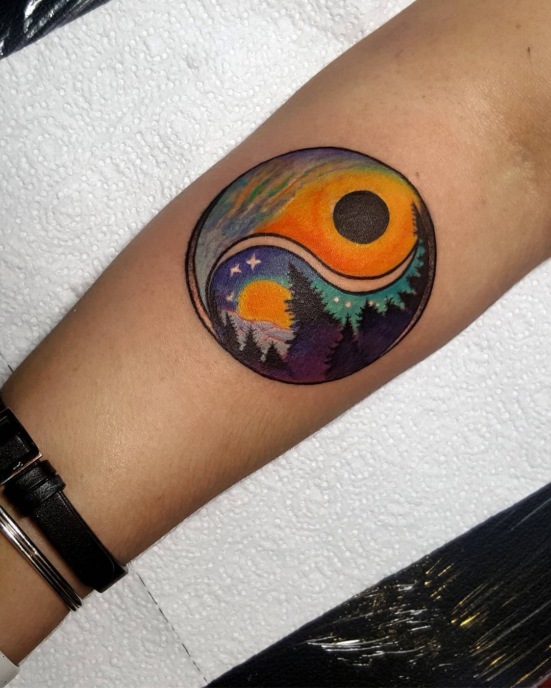 Nature-inspired yin yang tattoo with vibrant colors