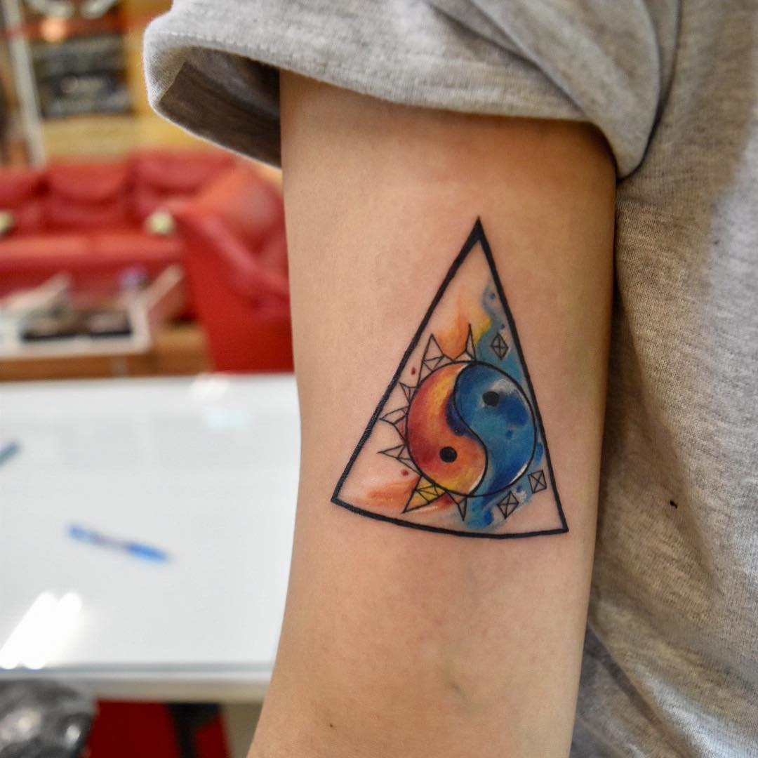 Vibrant Yin Yang Tattoo in Triangle Design