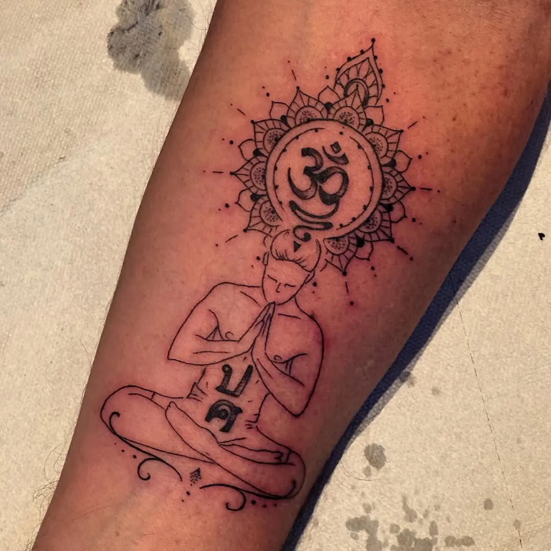 Intricate yoga-inspired tattoo with spiritual elements